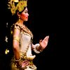 SIEM REAP, CAMBODIA – May 2012: A traditional Khmer Cambodian female dancer in Apsara dance pose against black