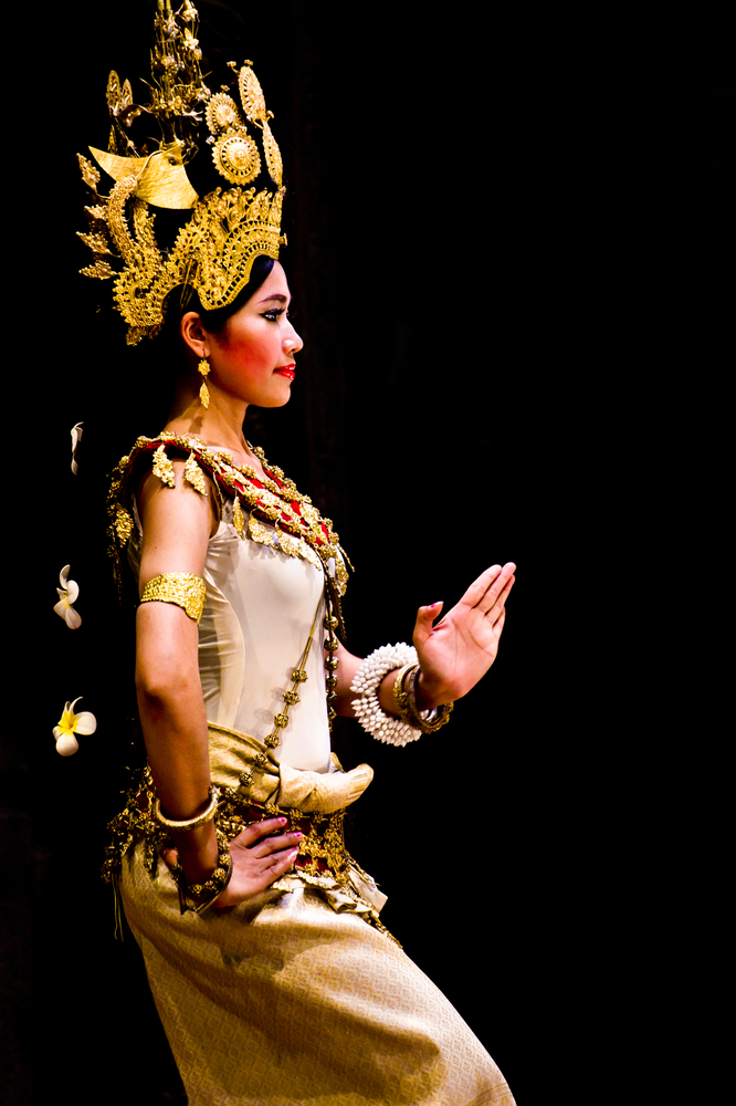 SIEM REAP, CAMBODIA – May 2012: A traditional Khmer Cambodian female dancer in Apsara dance pose against black