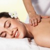 Portrait of a beautiful young woman lying on massage at spa center