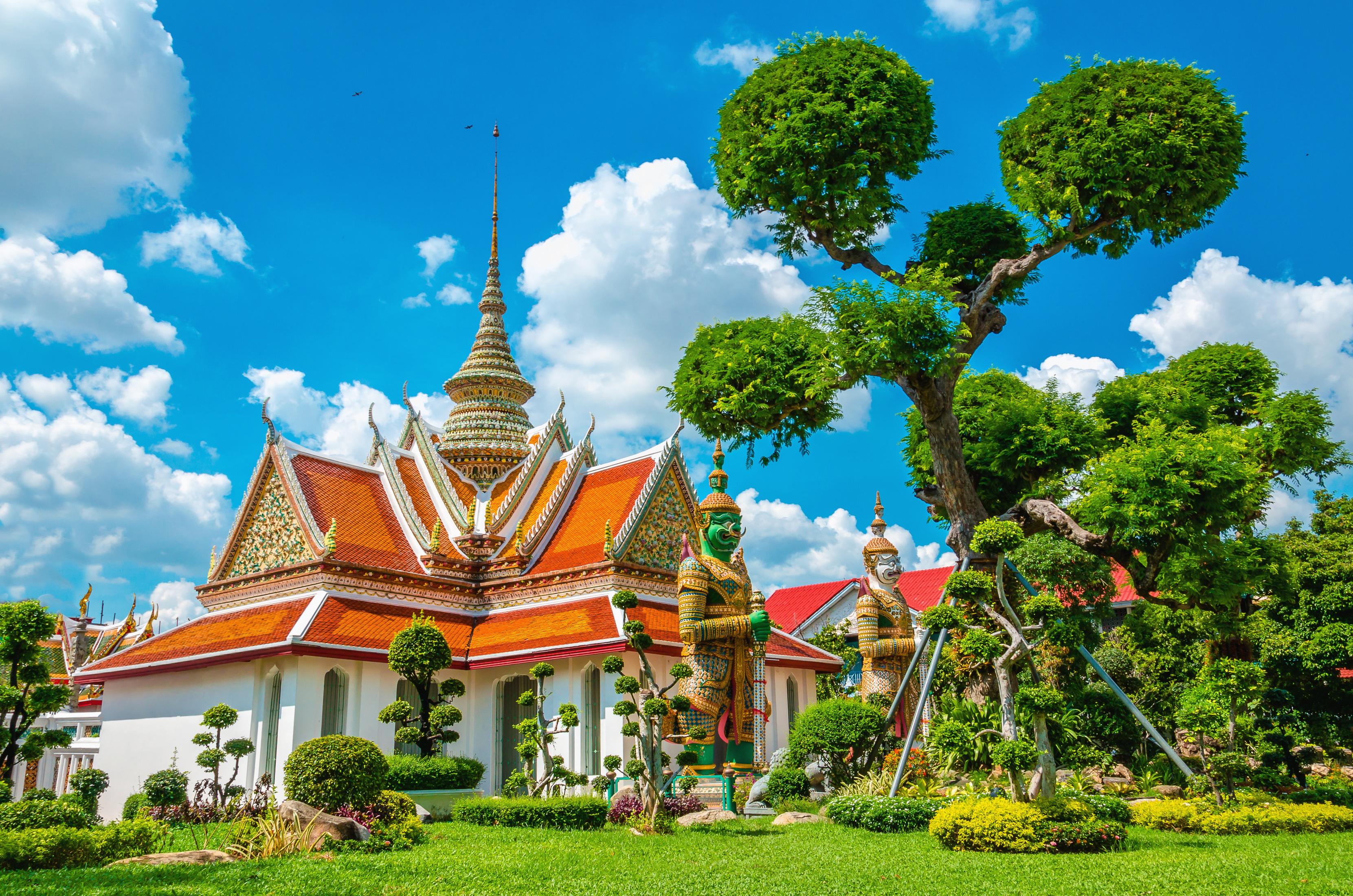 Great Palace Buddhist temple with famous green tree gardens in center of Bangkok, Thailand