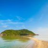 Summer seascape on tropical island Koh Phangan in Thailand. Mae Haad beach and Koh Ma landscape.